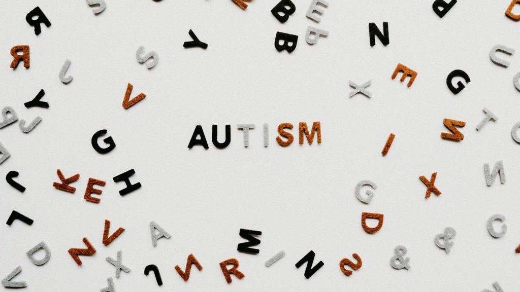 The word "Autism" is spelled out with small letters and surrounded by other small letters.